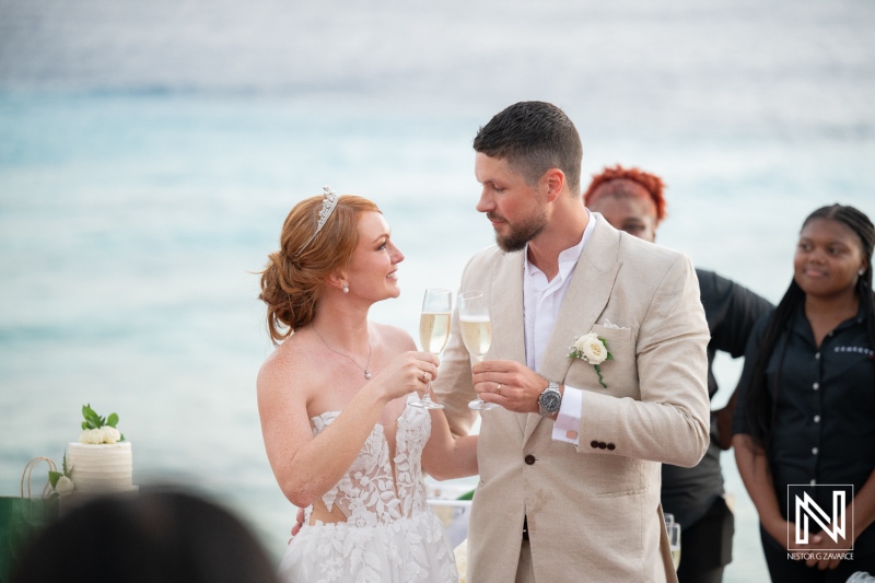 Couple celebrates their wedding with a toast at Karakter in Curacao during a stunning sunset