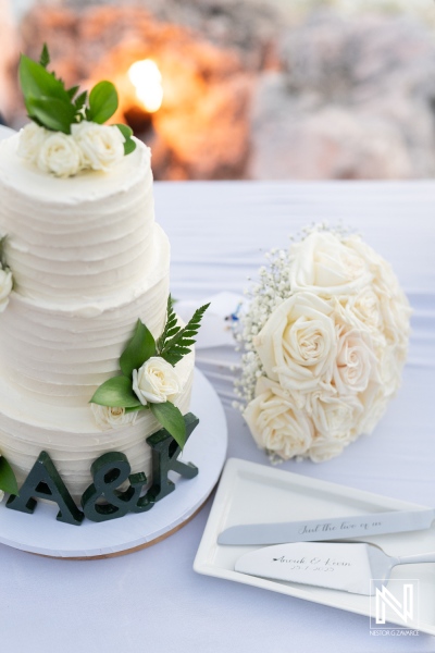 Beautiful wedding cake and bouquet at a stunning Curacao seaside venue