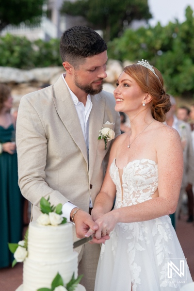 Couple shares a special moment while cutting their wedding cake at Karakter in Curacao