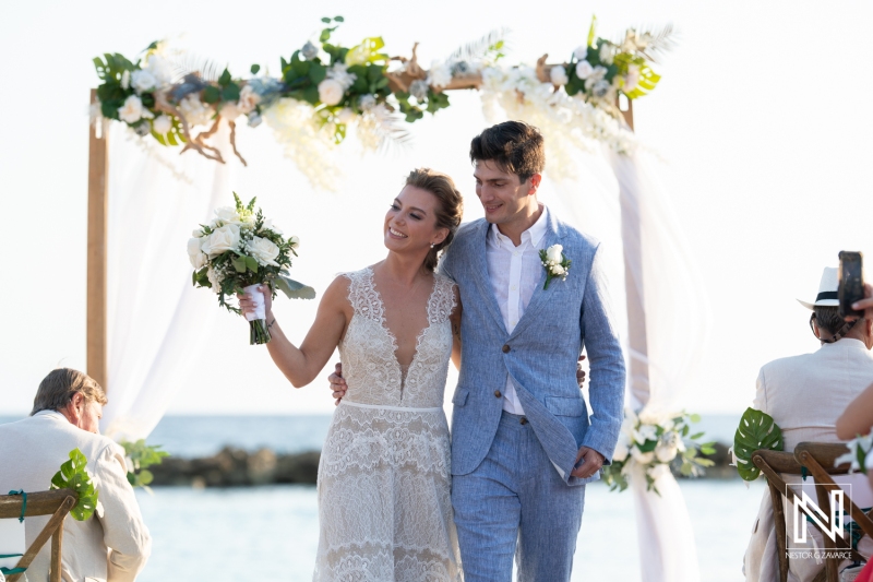 Bride and groom walking out the isle