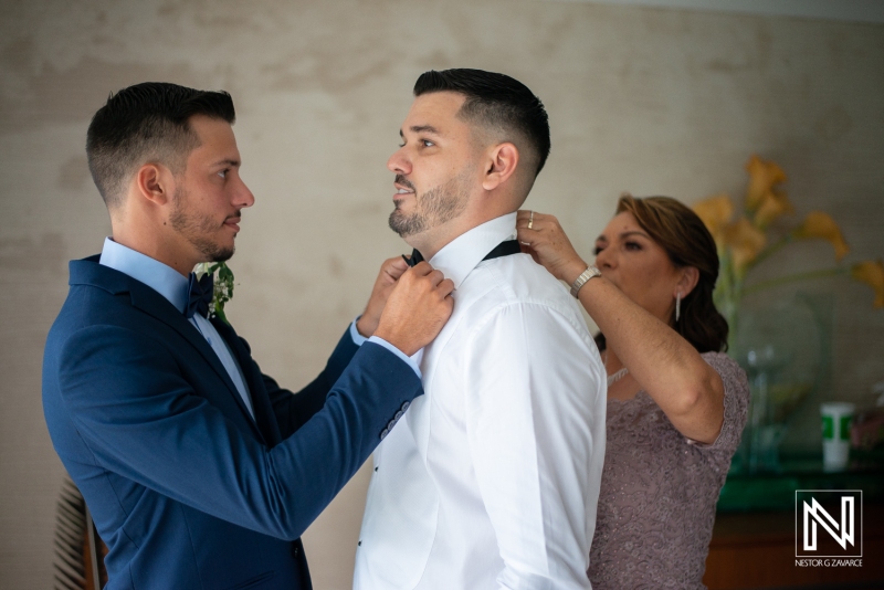 Groom getting into attire