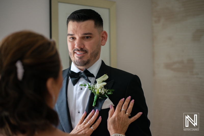 Groom getting into attire