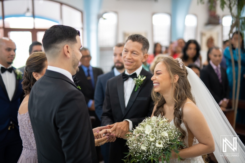 Dad gives bride's hand to the groom at the church