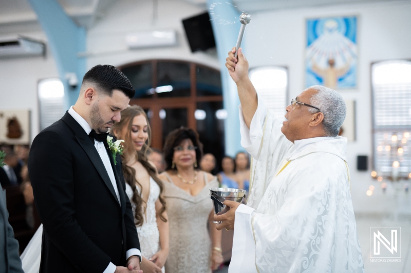 Priest gives holy water to bride and groom