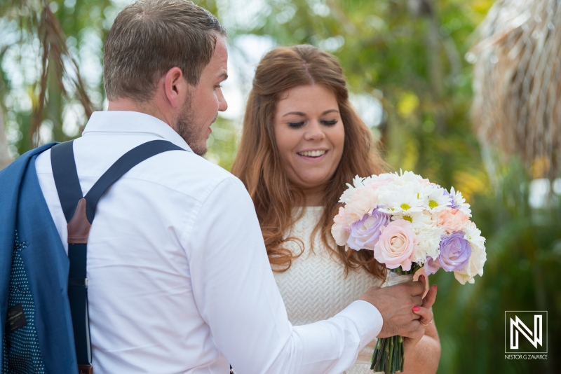 Groom giving bouquet of flowers to bride