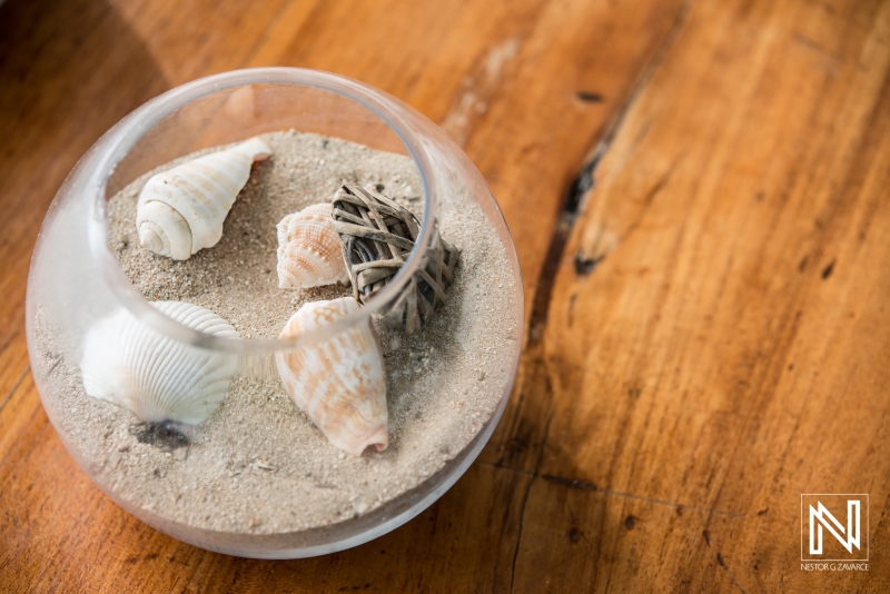 Glass with sand and sea shells