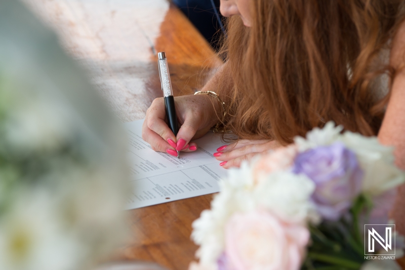 Bride signing the wedding document