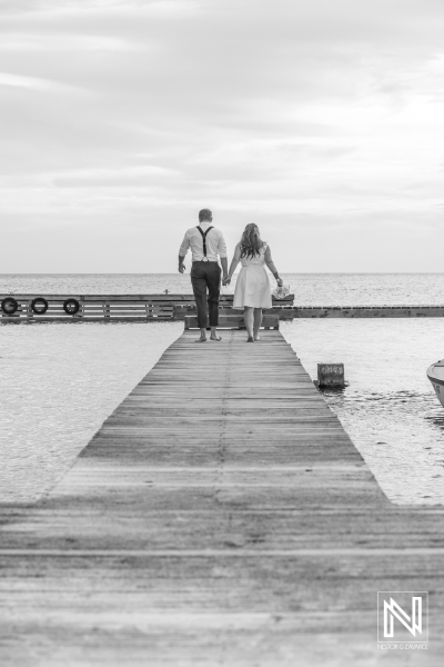 Bride and groom photoshoot on the beach pier