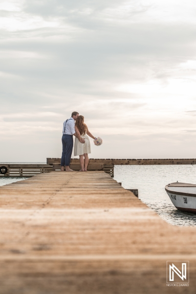 Bride and groom photoshoot on the beach pier