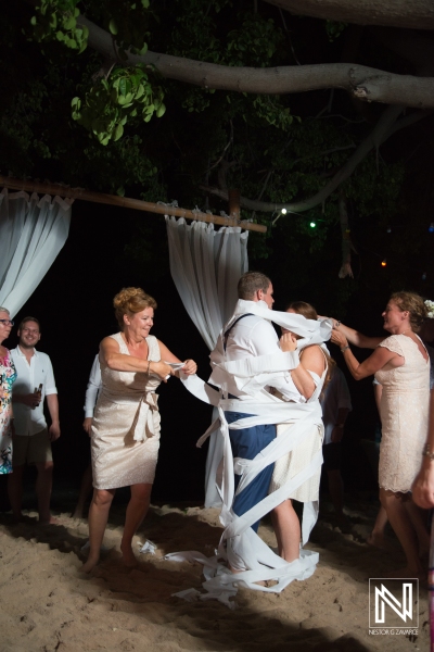 Bride and groom wrapped with toillet paper in the wedding party