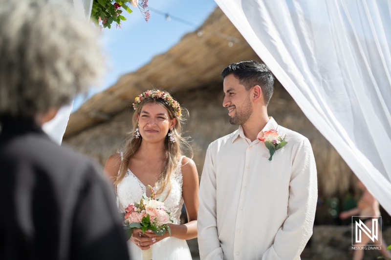 Bride and groom listening to the officiant speech