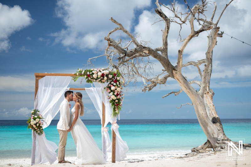 Couple's kiss at the beach wedding gazebo