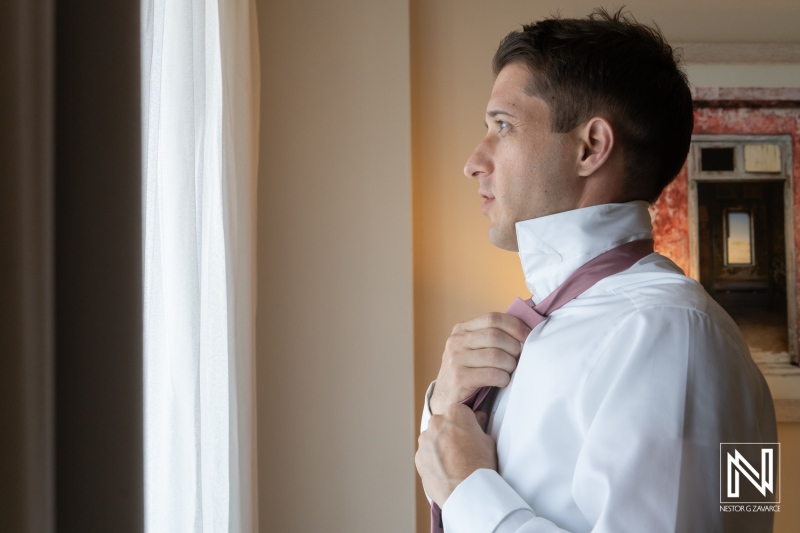 Celebration of a wedding at Dreams Curacao Resort with a groom getting ready in a room