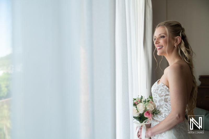 Wedding celebration at Dreams Curacao Resort with bride looking out the window