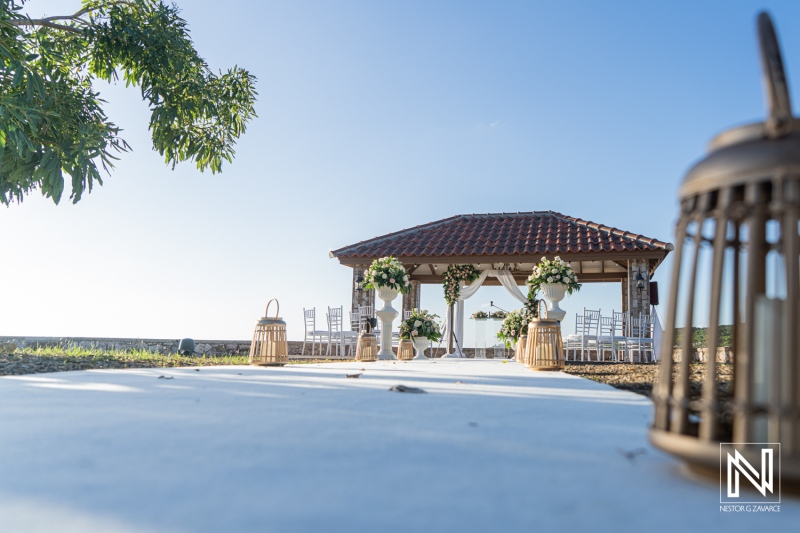Wedding setup at Dreams Curaçao Resort features flowers and decorations under blue sky