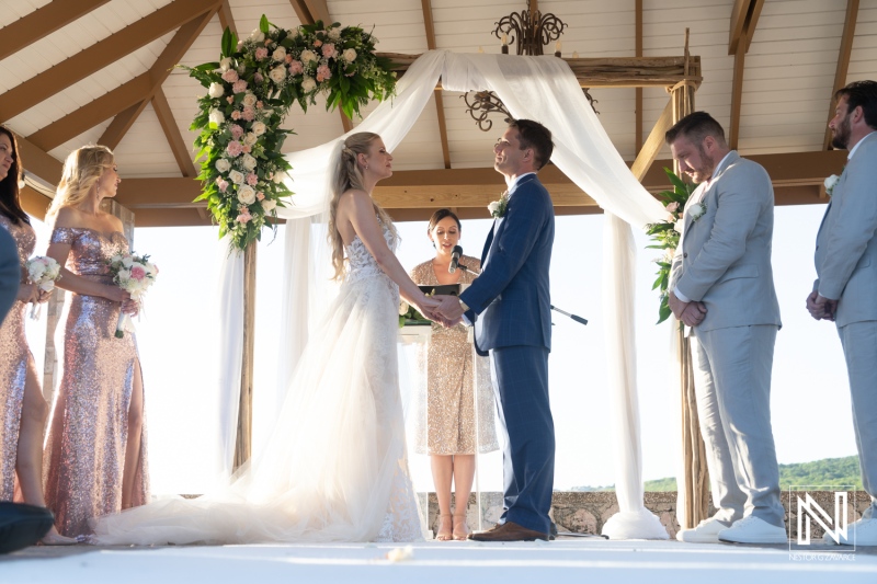 Wedding ceremony at Dreams Curacao Resort with couple exchanging vows and guests attending