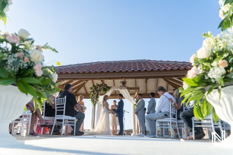 Wedding ceremony takes place at Dreams Curacao Resort with guests witnessing the exchange of vows