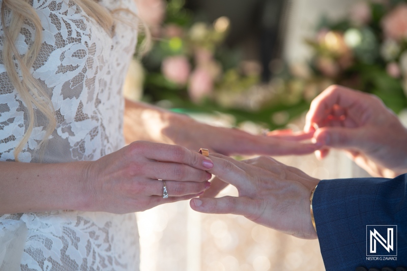 Couple exchanges wedding rings during ceremony at Dreams Curacao Resort in Curacao in the afternoon