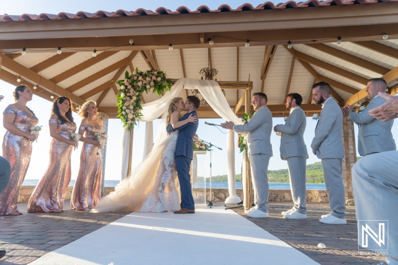 Couple exchanges vows at wedding ceremony at Dreams Curacao Resort with guests in attendance