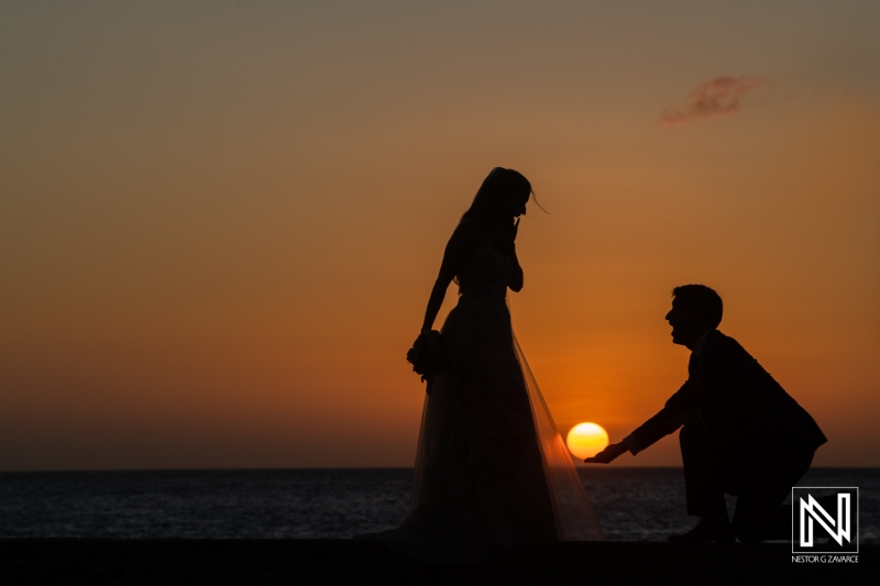 Couple exchanges vows at sunset during wedding ceremony at Dreams Curacao Resort in Curacao