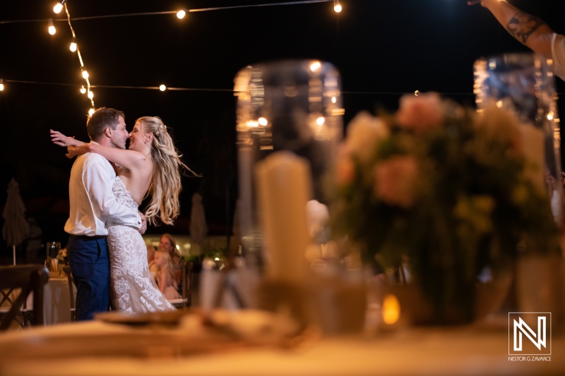 Couple dances together at their wedding reception at Dreams Curacao Resort under string lights