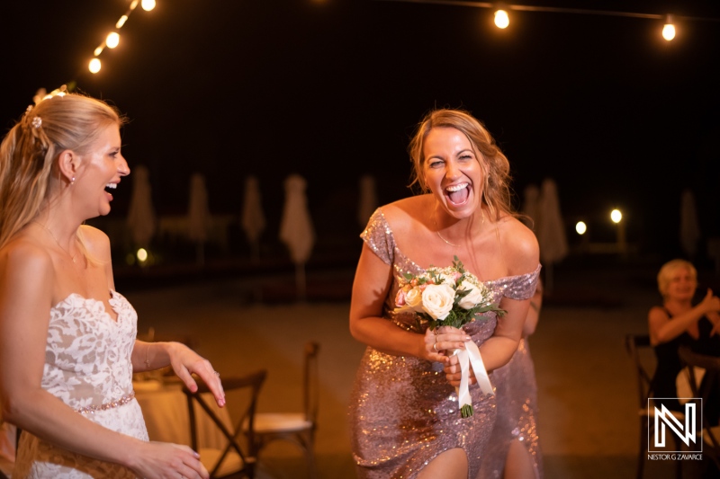 Fun moments during a wedding celebration at Dreams Curacao Resort with lively guests enjoying the night events outdoors