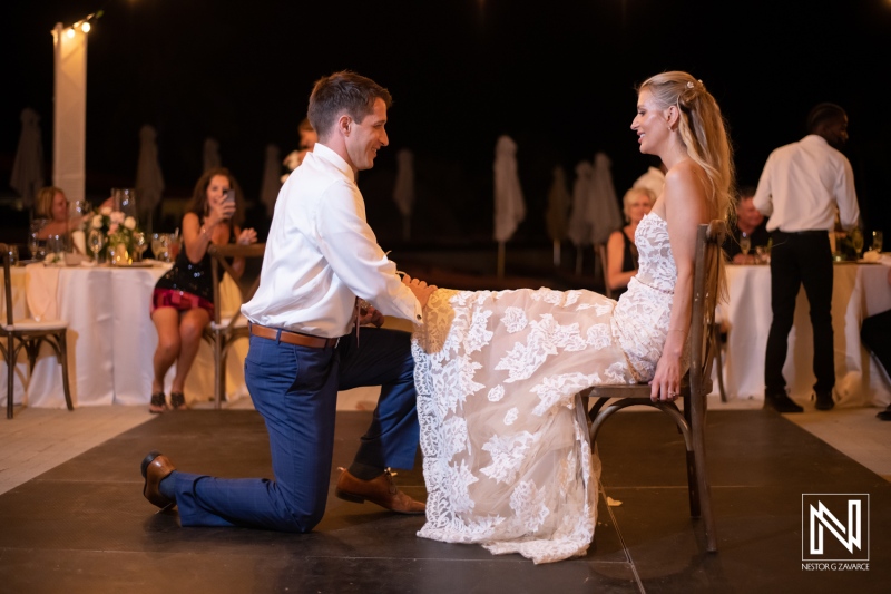 Couple shares a special moment during their wedding reception at Dreams Curacao Resort in the evening light