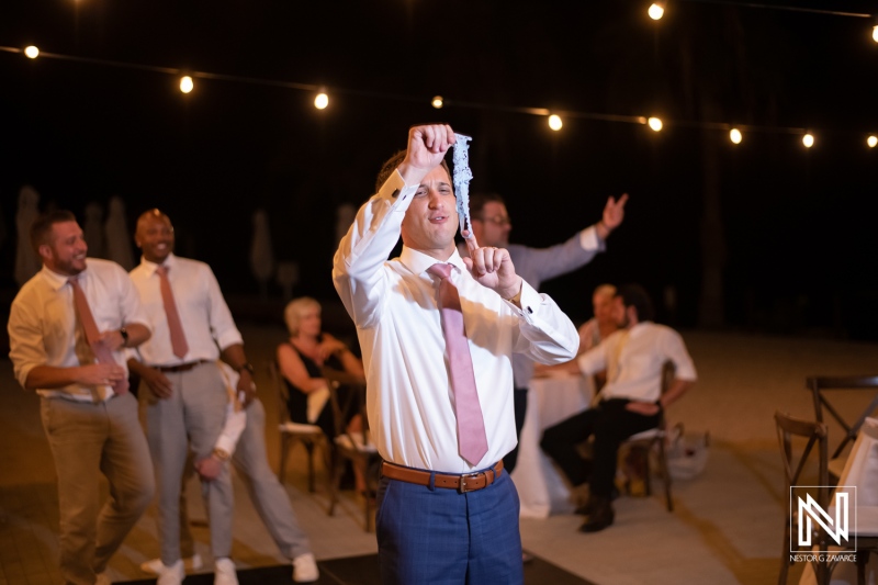 Wedding celebration at Dreams Curacao Resort with guests enjoying a lively moment during the reception