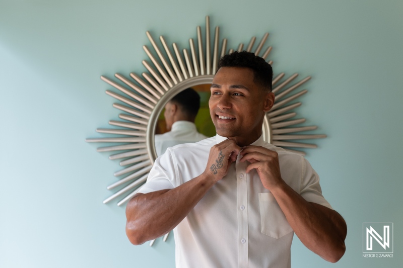 Groom preparing for wedding ceremony at Sunscape Curacao Resort with a bright mirror backdrop