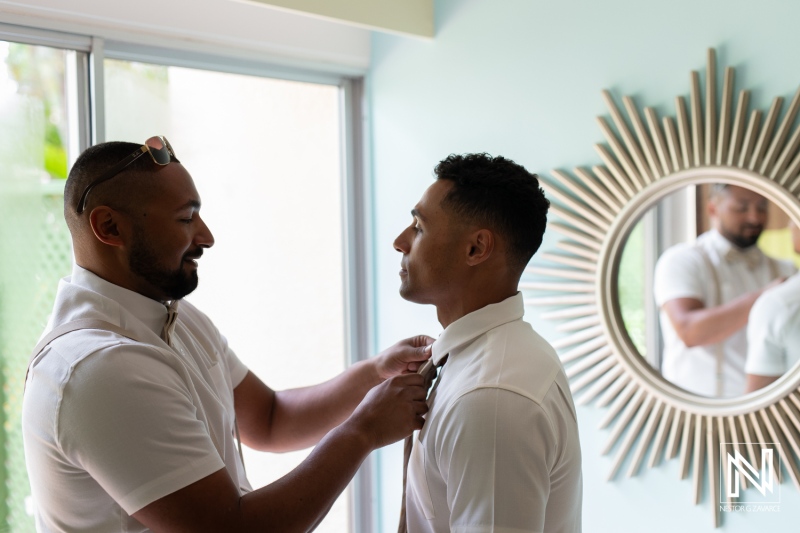 Groom getting ready for wedding ceremony at Sunscape Curacao Resort surrounded by friends and capturing special moments