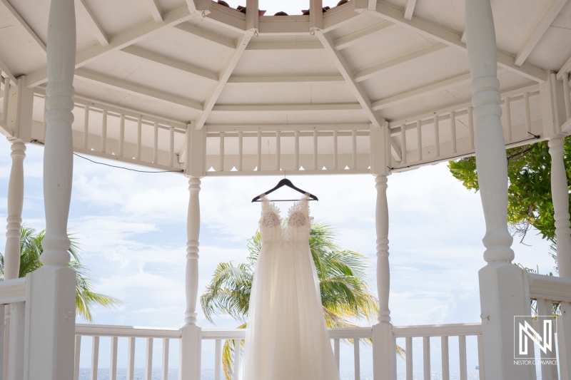 Beautiful wedding dress displayed in a gazebo overlooking the stunning landscape of Curacao at Sunscape Curaçao Resort