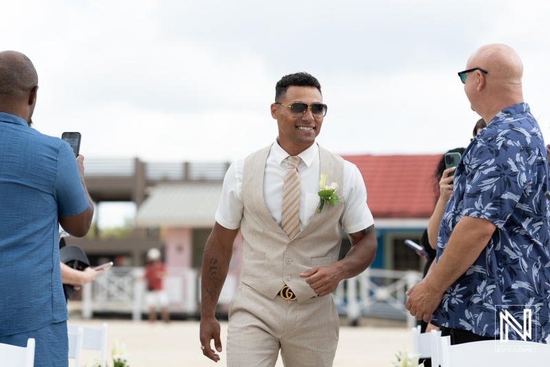 Groom walking down the aisle at a beach wedding ceremony in Curacao, celebrating love at Sunscape Curaçao Resort