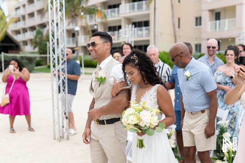 Couple joyfully walking down the aisle at a wedding ceremony in Curacao's Sunscape Resort