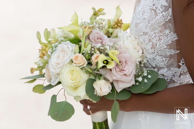 Elegant bridal bouquet showcases roses and greenery at a beautiful wedding ceremony in Curacao, featuring Sunscape Curaçao Resort