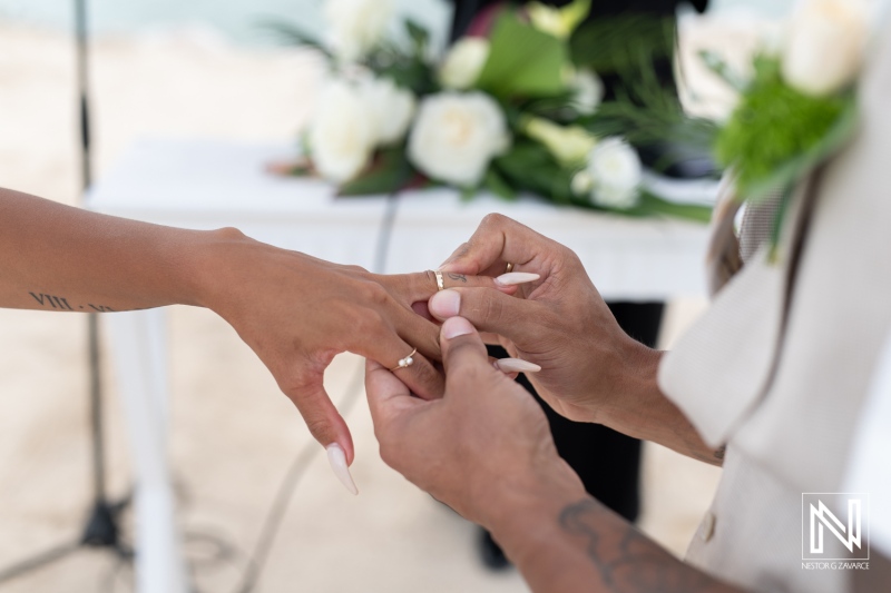 Couple exchanges wedding rings during a beautiful ceremony at Sunscape Curacao Resort on a sunny day