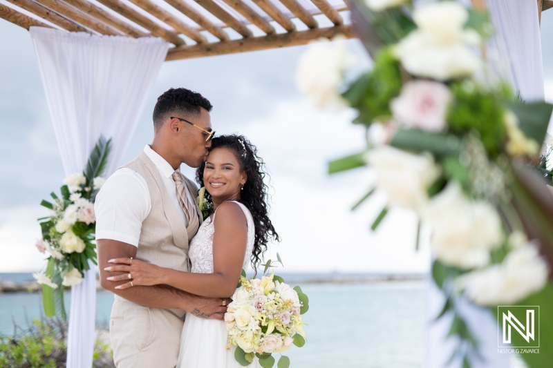 Couple exchanges vows during a romantic wedding ceremony at Sunscape Curacao Resort amidst a beautiful coastal backdrop