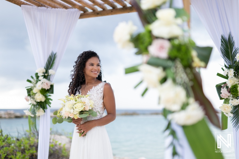 Memorable wedding ceremony at Sunscape Curacao Resort with a radiant bride holding a beautiful bouquet against the serene Caribbean backdrop