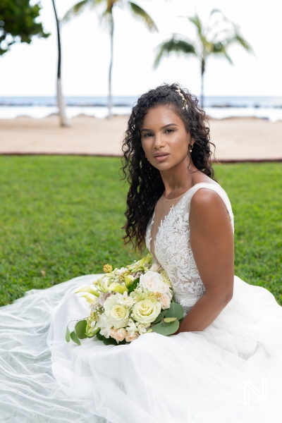 Beautiful bride poses elegantly on the lawn at Sunscape Curacao Resort during her wedding celebration