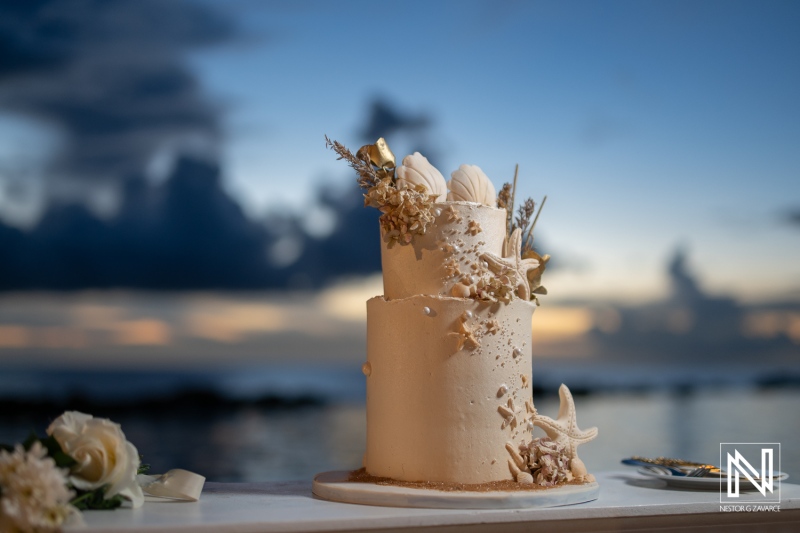 Wedding cake decorated with seashells at Sunscape Curacao Resort during a beautiful sunset