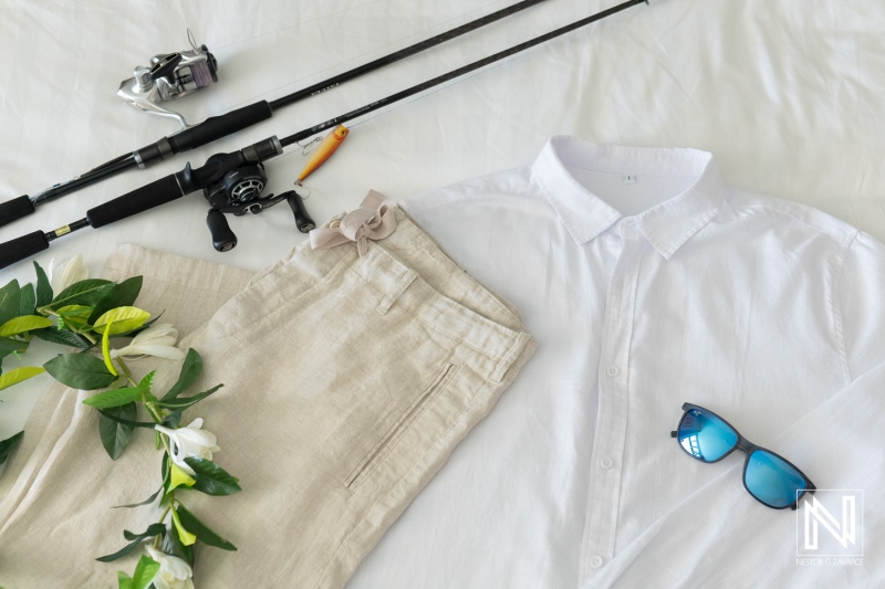 Wedding attire and fishing gear prepared for a sunset celebration at Avila Beach Hotel in Curacao, capturing a blend of romance and adventure