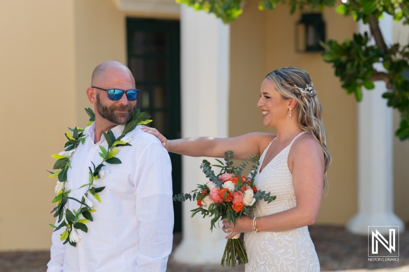 Wedding ceremony at sunset in Avila Beach Hotel, Curacao with a bride and groom celebrating their special day