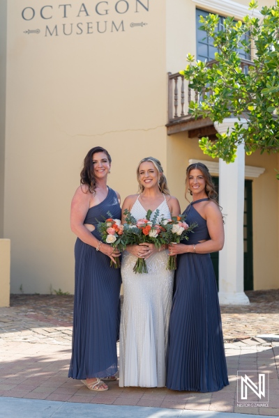 Beautiful wedding party at Avila Beach Hotel in Curacao during sunset capturing joyous moments and elegant attire