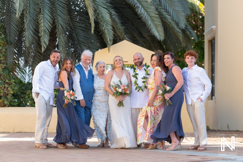 Beautiful wedding celebration at Avila Beach Hotel in Curacao during a stunning sunset with loved ones gathered together