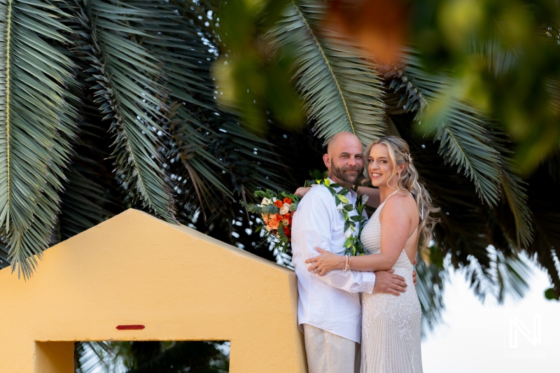 Romantic wedding ceremony at Avila Beach Hotel in Curacao during a stunning sunset with a beautiful couple celebrating their love