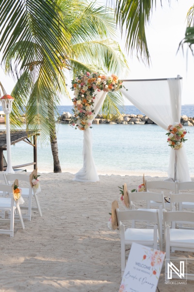 A beautiful wedding ceremony setup at Avila Beach Hotel in Curacao during a serene sunset by the ocean