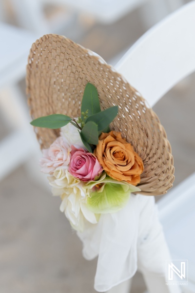 Elegant floral arrangement on a straw fan at a wedding ceremony in Curacao at Avila Beach Hotel during a beautiful sunset