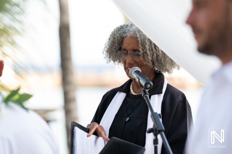 Wedding ceremony at Avila Beach Hotel during a stunning sunset in Curacao with an officiant addressing the couple