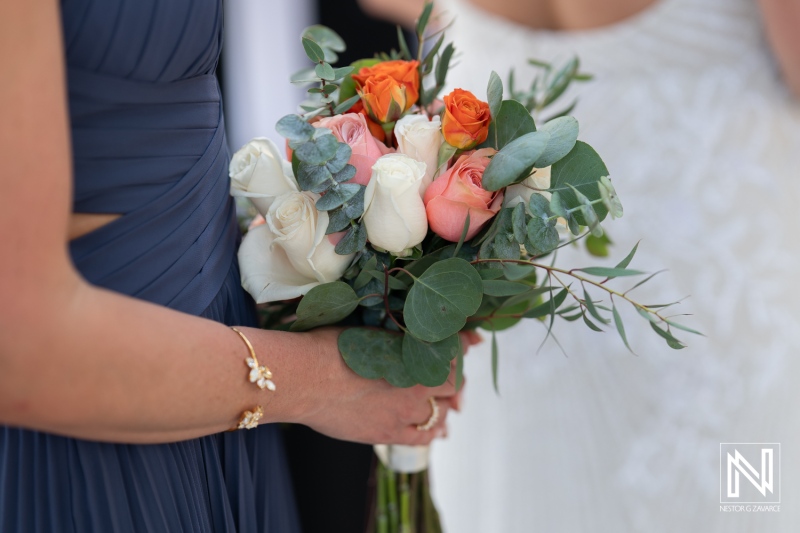 Stunning wedding bouquet featuring roses and eucalyptus at a romantic sunset wedding in Curacao