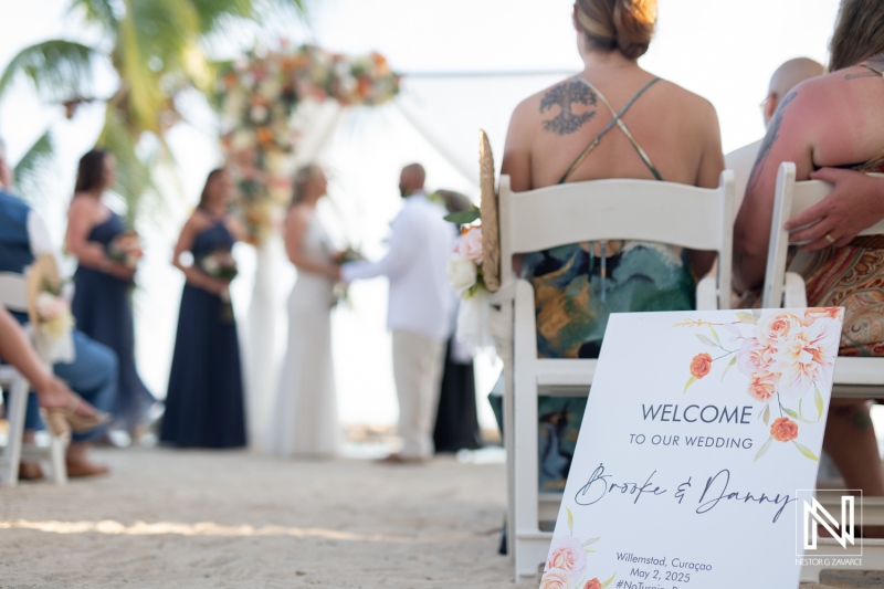 Wedding ceremony at Avila Beach Hotel in Curacao with sunset backdrop and beautiful decor on May 2, 2025