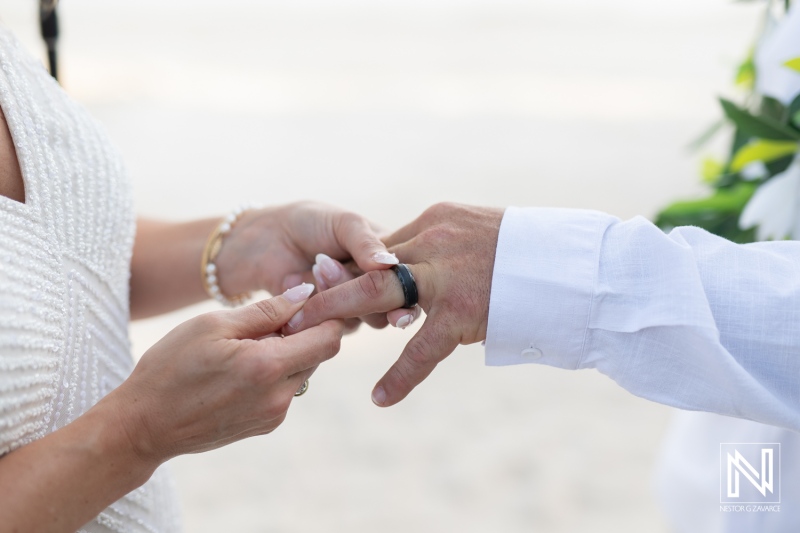 Ceremony at Avila Beach Hotel in Curacao during a beautiful sunset with a couple exchanging wedding rings